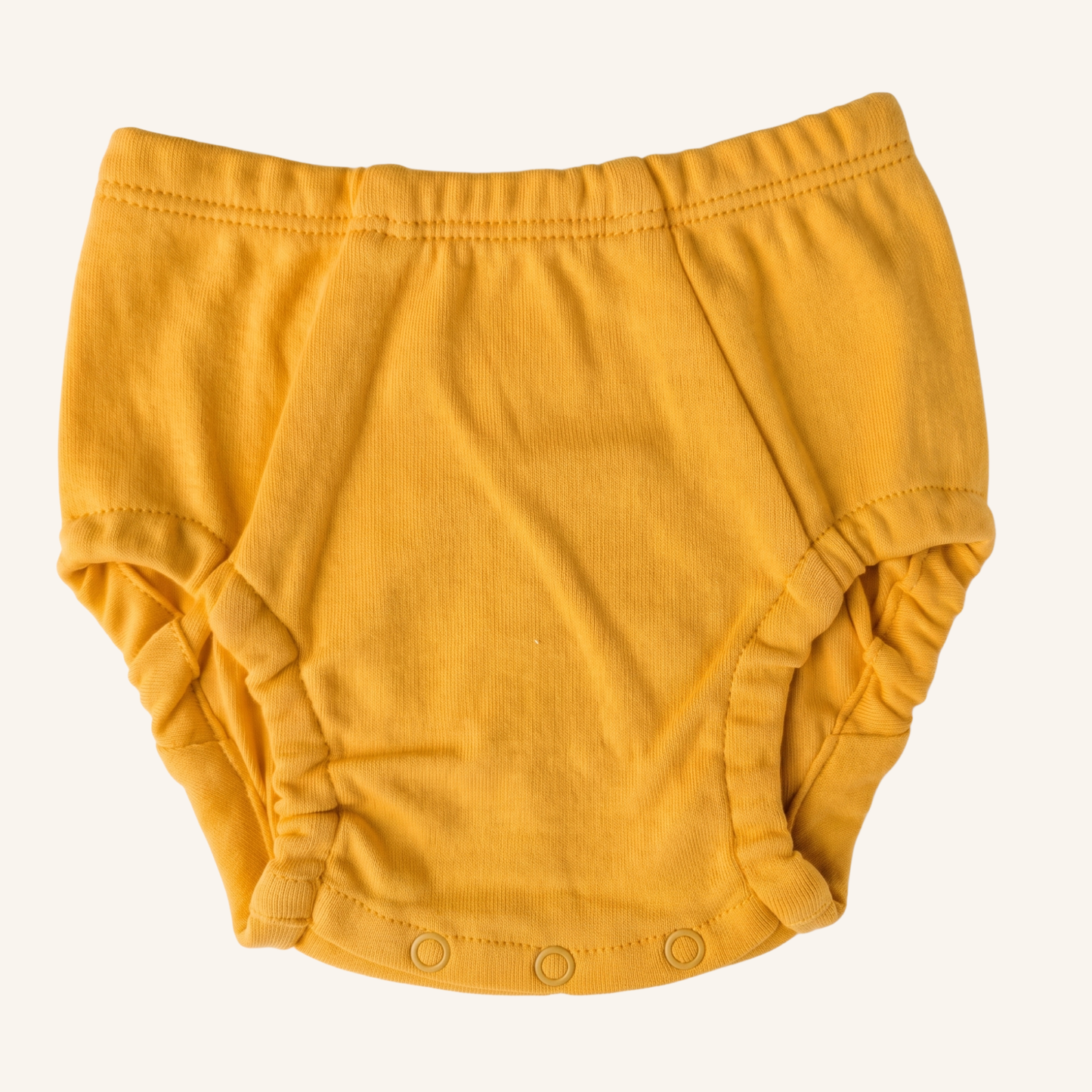 Yellow baby bloomers on a white background