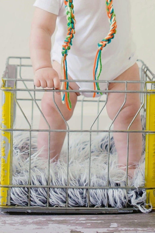 Close our to baby standing in the crib 