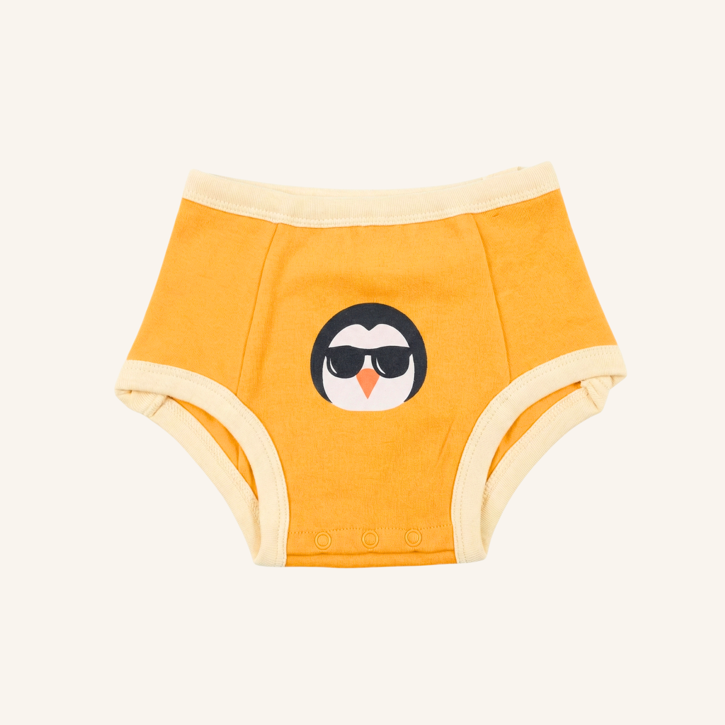 Yellow children's nighttime underwear with a penguin design on a white background