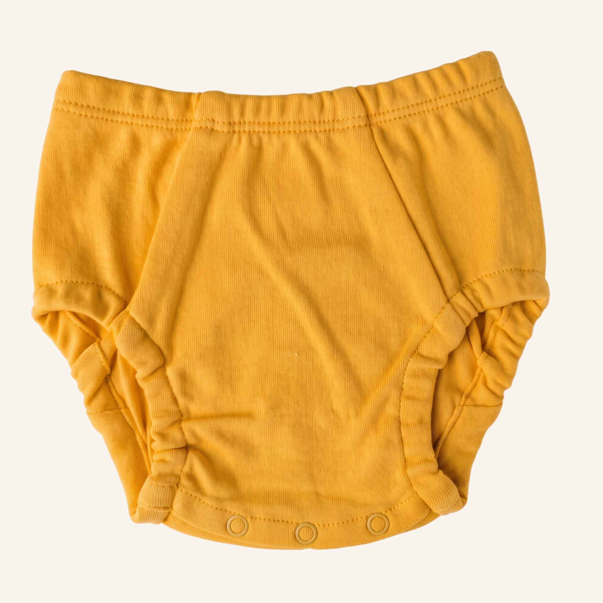 Yellow baby bloomers on a white background