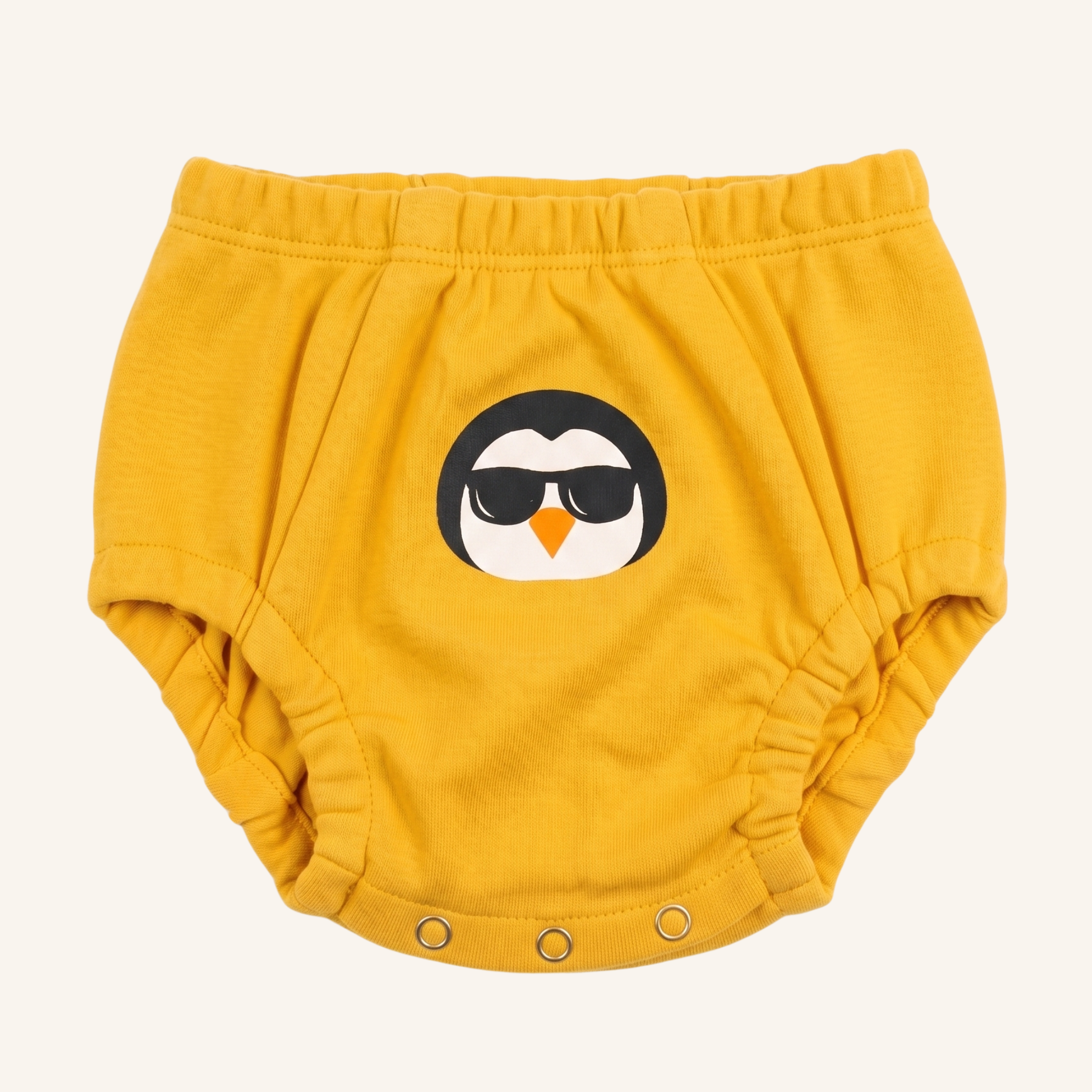 Yellow baby bloomers with a penguin design on a white background
