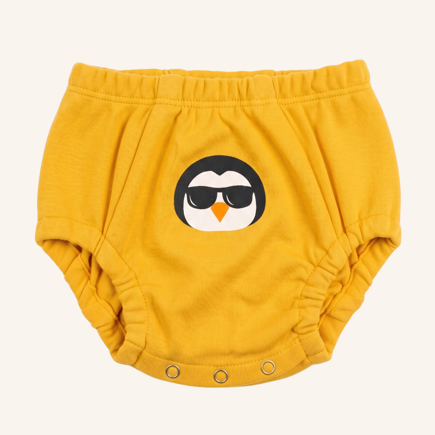 Yellow baby bloomers with a penguin design on a white background