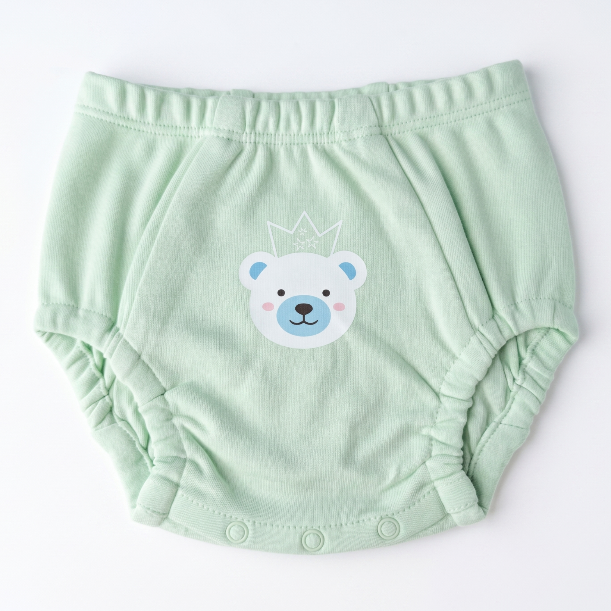 Light green baby bloomers with a bear face design on a white background