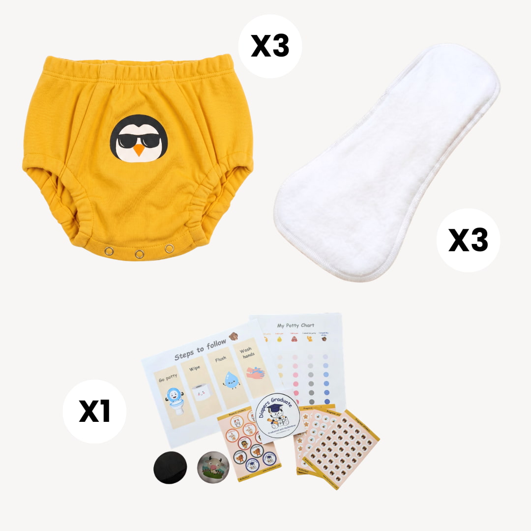 Yellow training pants with penguin design, white wipes, and educational cards on a white background